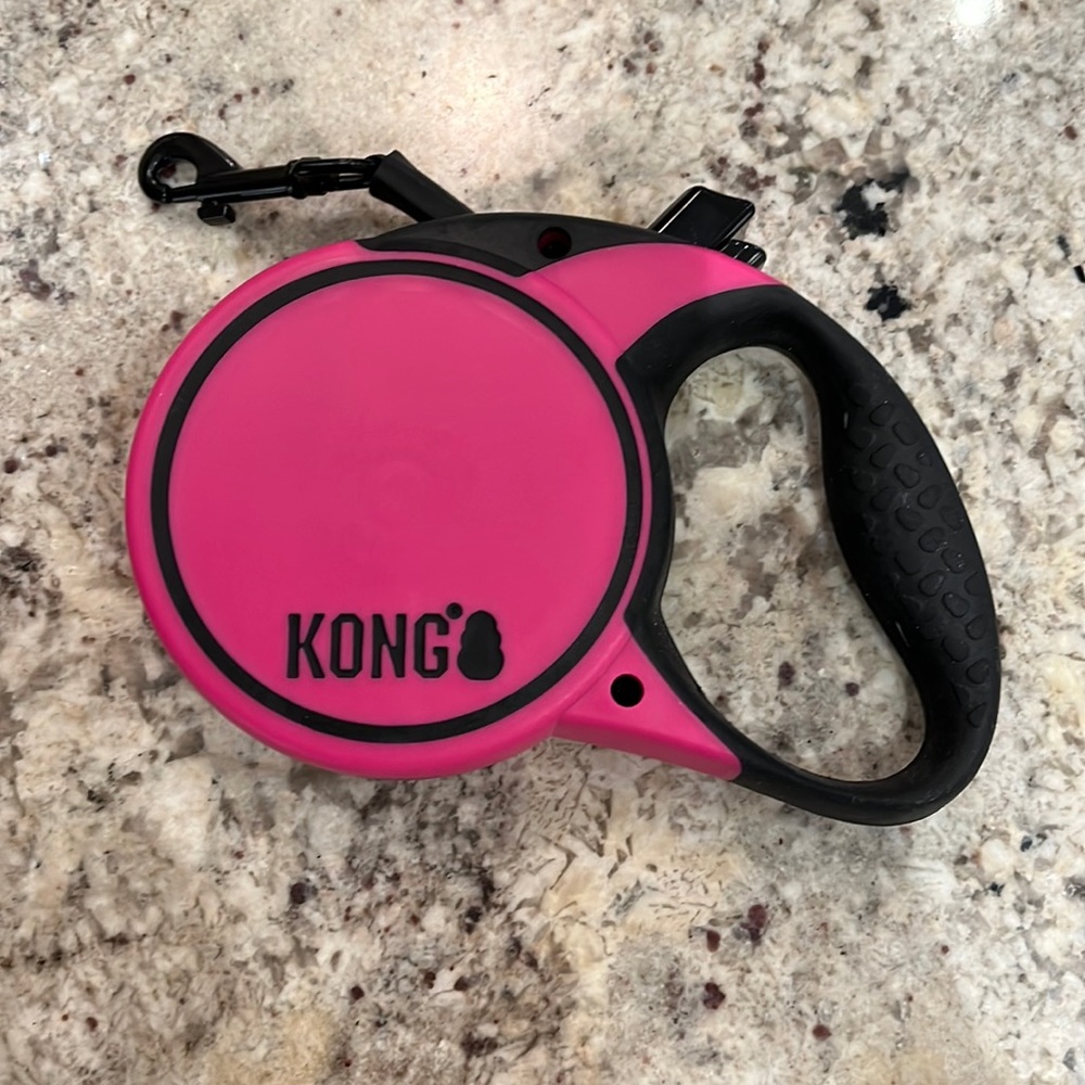 Kong retractable pink leash. Approximately 16 ft. Maximum dog weight 45 lbs.